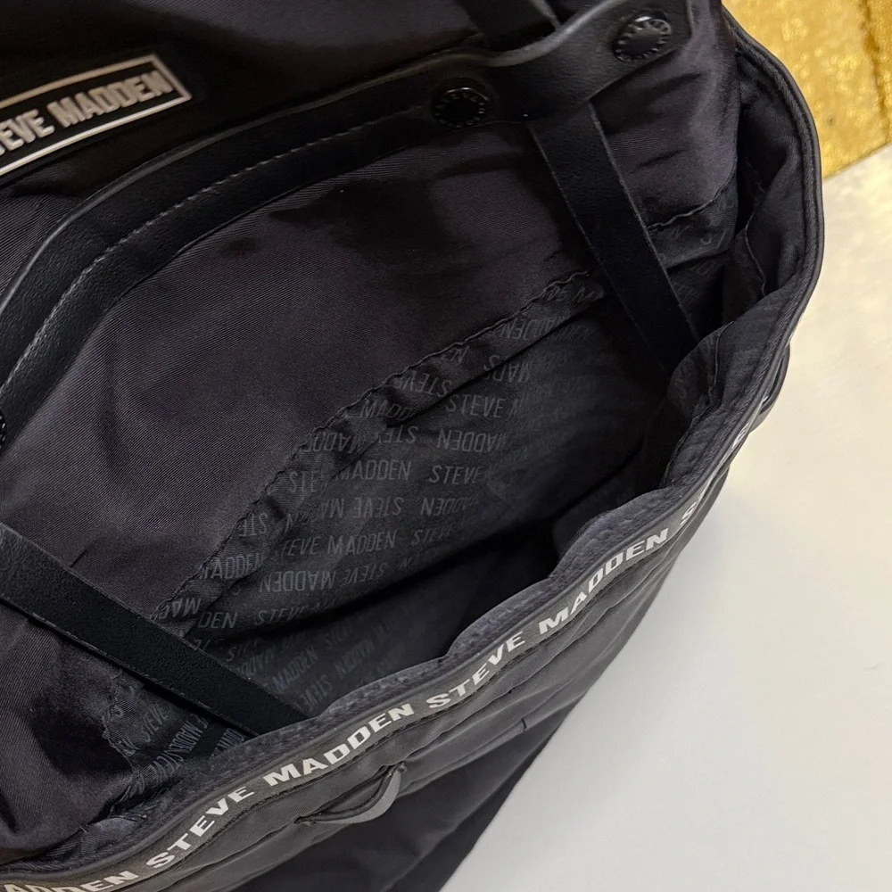 Steve Madden Bjodah Black Quilted Backpack with carry handles and branded strap